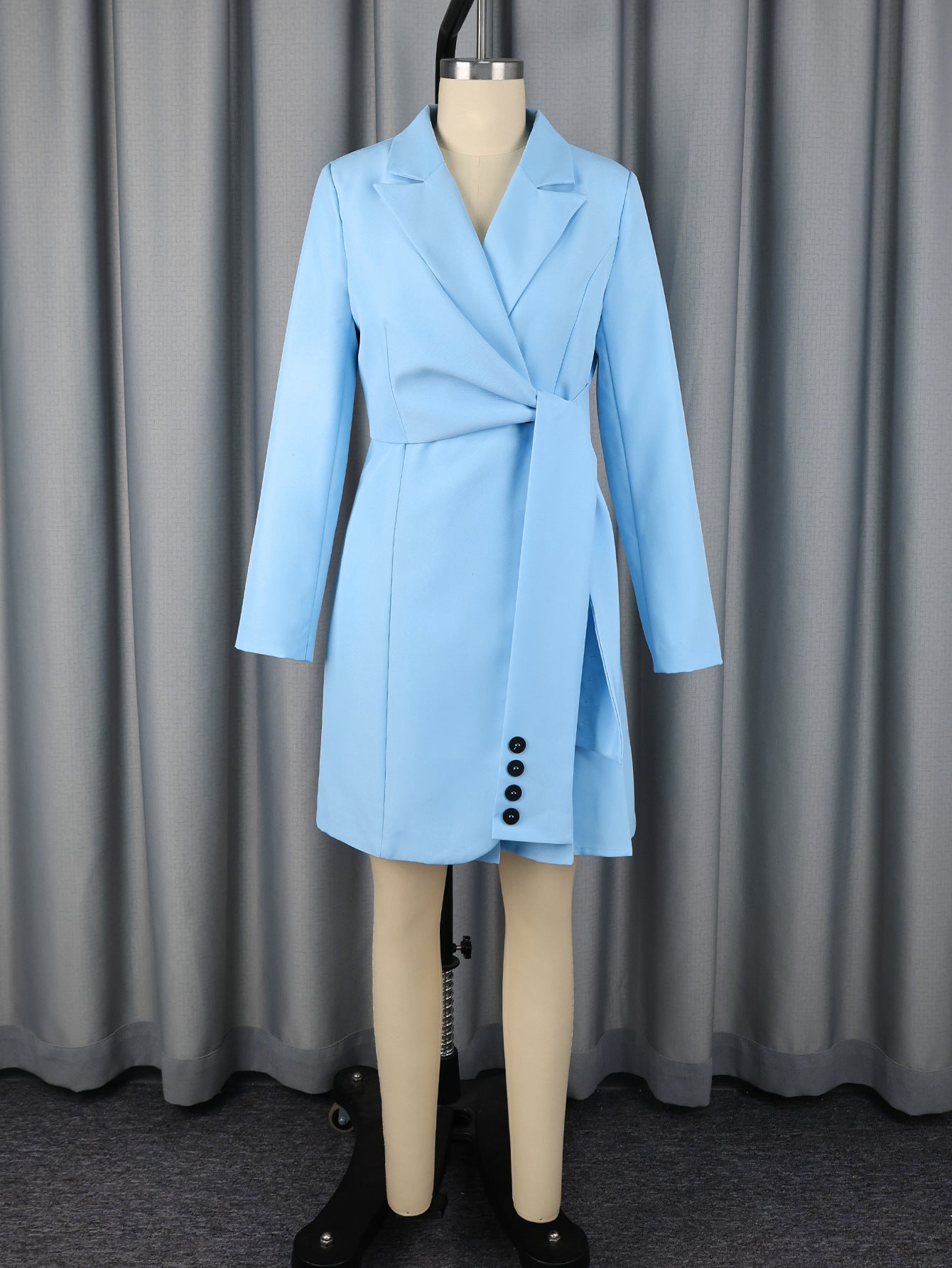Blue lapel wrap mini blazer dress on mannequin with long sleeves and front button placket