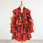 Red ruffle mini dress with V-neck and tie waist, layered flutter sleeve details.