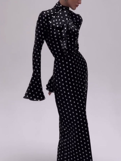 Black polka dot bell-sleeve dress with high neck and fitted midi silhouette
