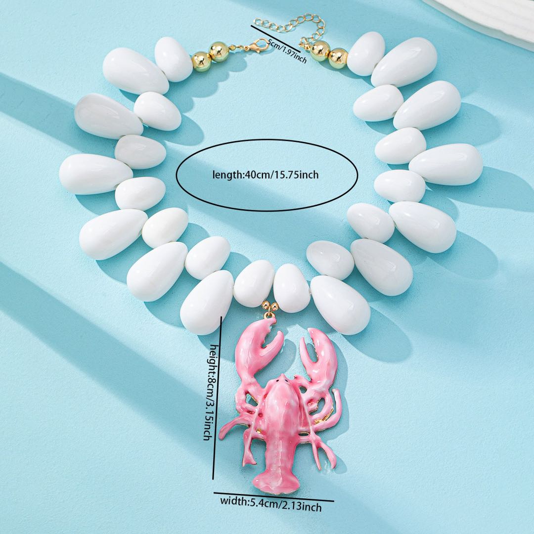 Chunky lobster pendant necklace with white oval beads and pink lobster charm on chain