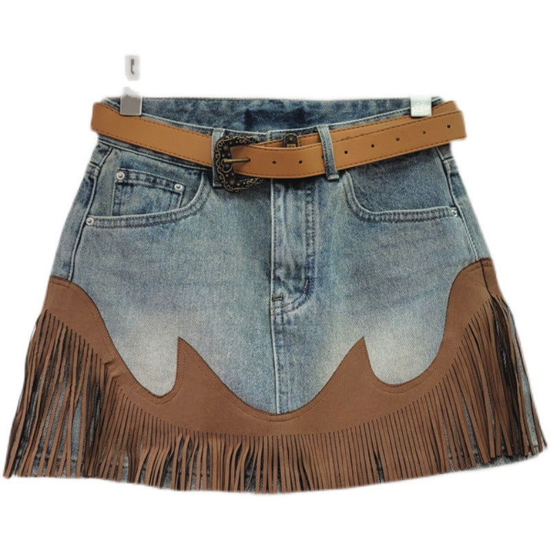 Light blue denim mini skirt with tan waist belt and brown fringe tassel hem