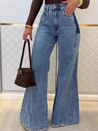 Light blue high-waist flared jeans with belt loops, front button, and long wide flare