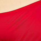 Red woven fabric panel with visible seam stitching