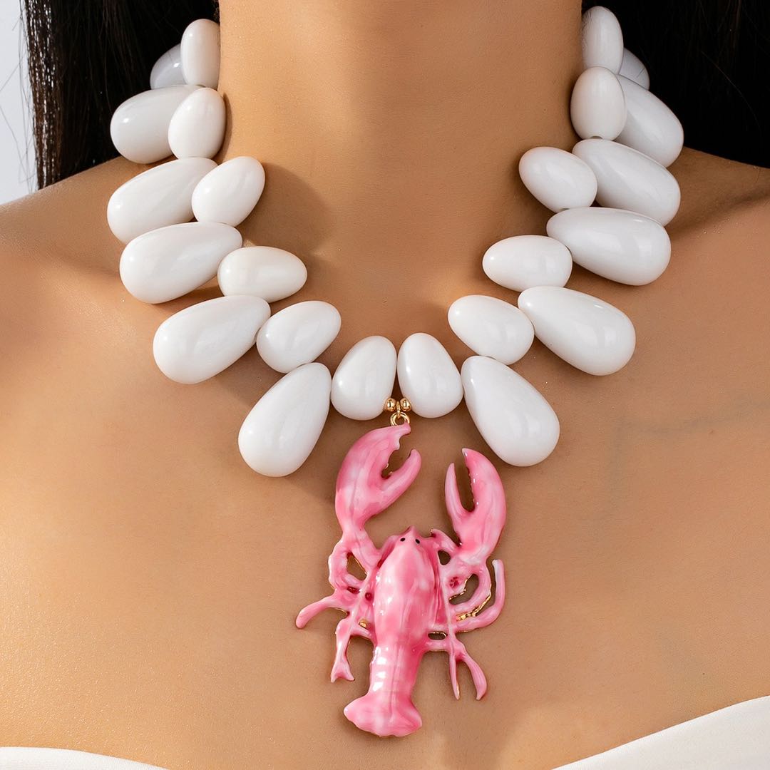 Chunky lobster pendant necklace with white oval beads and pink lobster charm