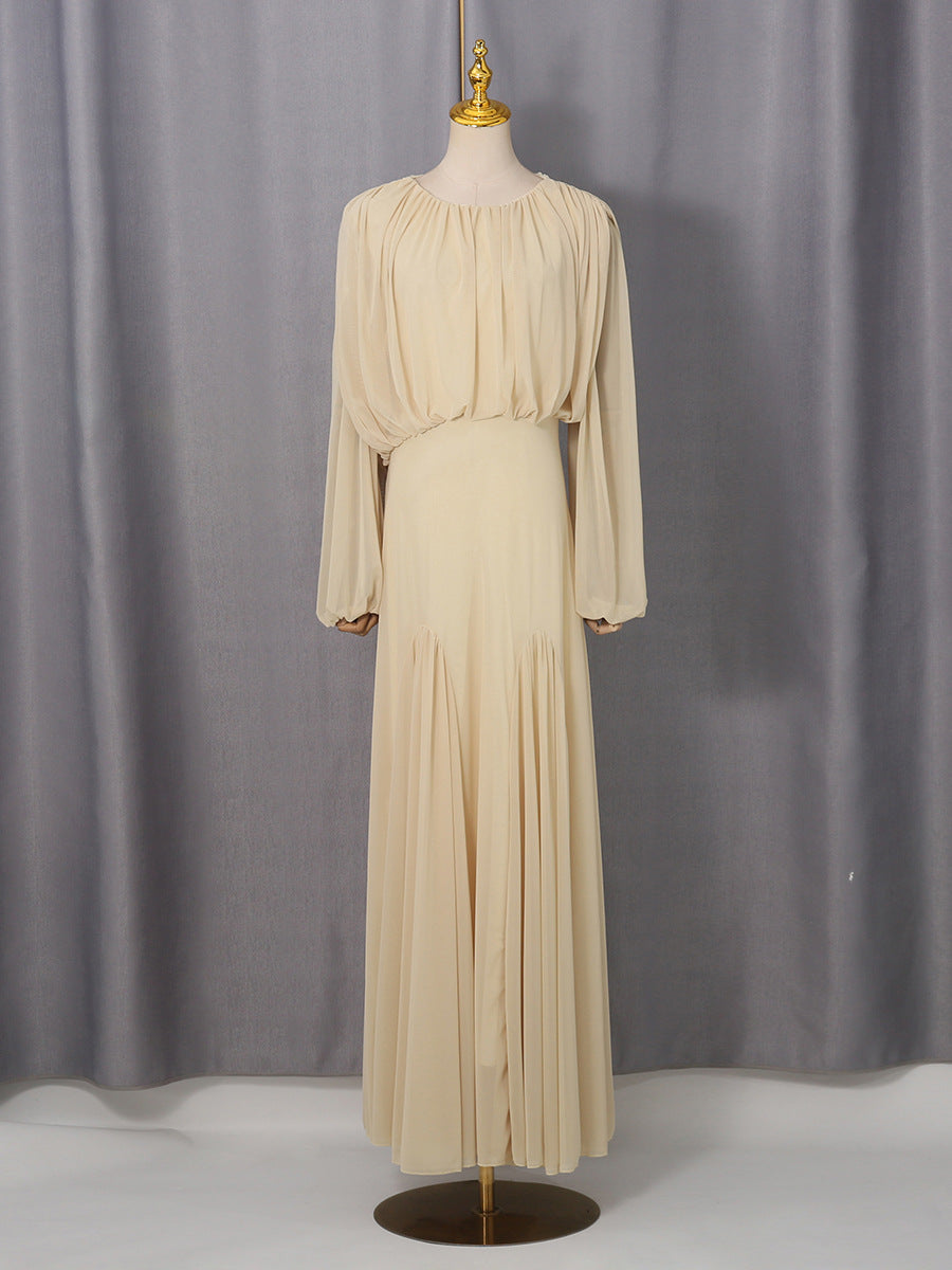 Cream pleated maxi dress with long sleeves and softly draped shoulders