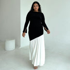 Round-neck long-sleeve dress, black top with white pleated maxi skirt, angled pose