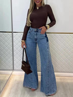 Light blue high-waist flared jeans, front view with button-fly and side pockets