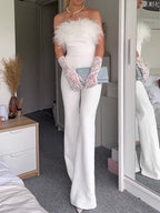 White wide-leg off-shoulder jumpsuit with feather accents, plus long feathered wrist cuffs