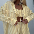 Yellow striped lounge jacket over ruched crop top and button-front shorts