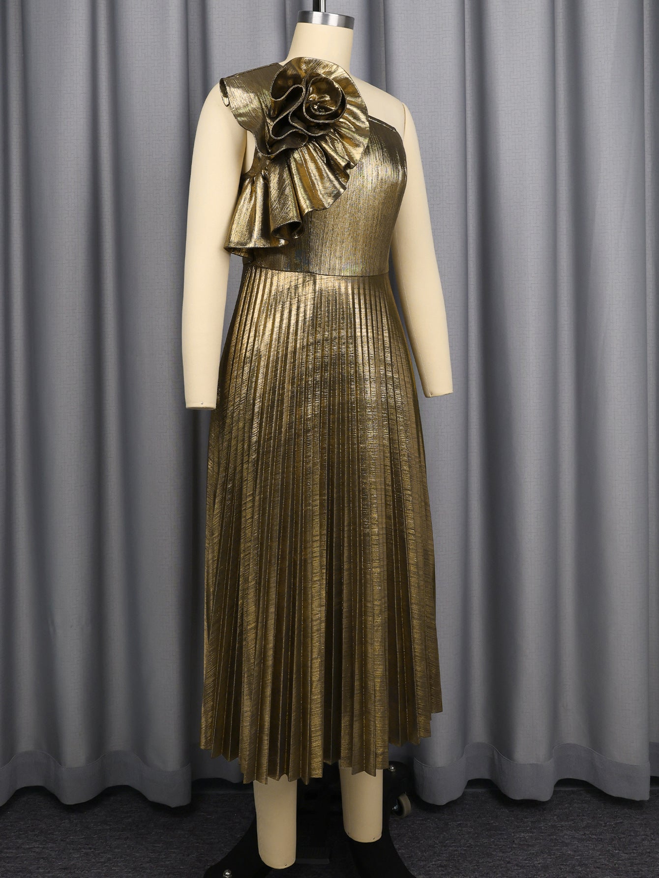 Gold one-shoulder pleated midi dress on mannequin with floral applique detail