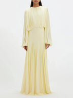 Pale yellow pleated maxi dress with long sleeves and gathered waistline