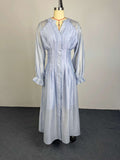 Light blue button-front flowy dress with puff sleeves and gathered waist