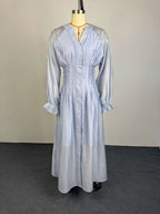 Light blue button-front flowy dress with puff sleeves and gathered waist