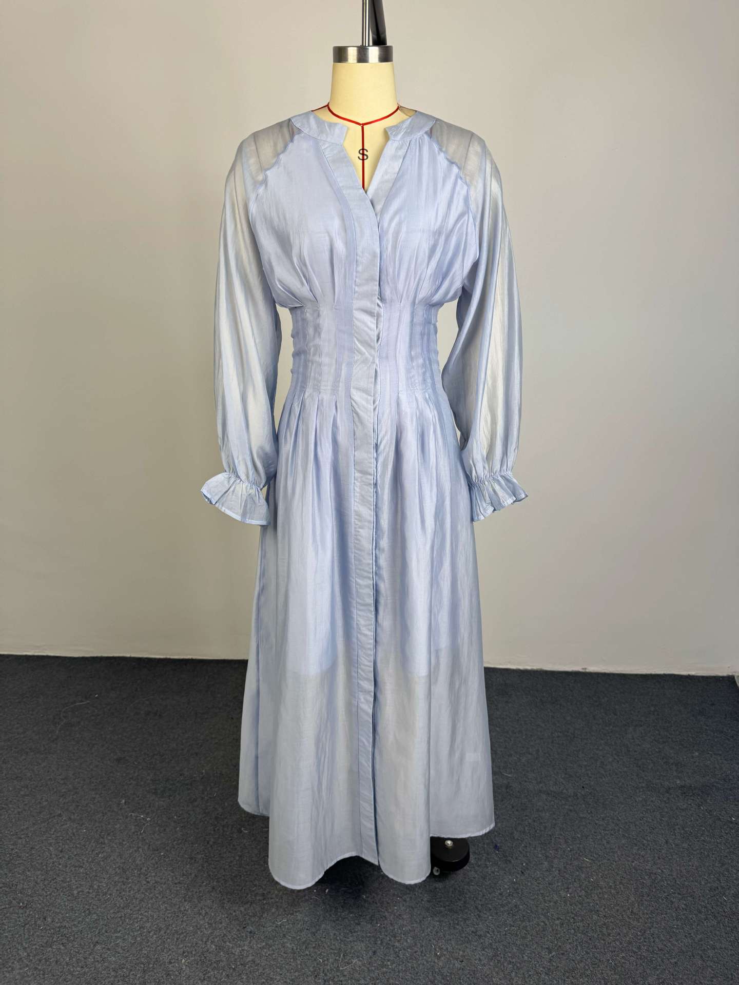 Light blue button-front flowy dress with puff sleeves and gathered waist