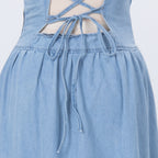 Light blue denim dress bodice with lace-up back ties and gathered skirt ruffle