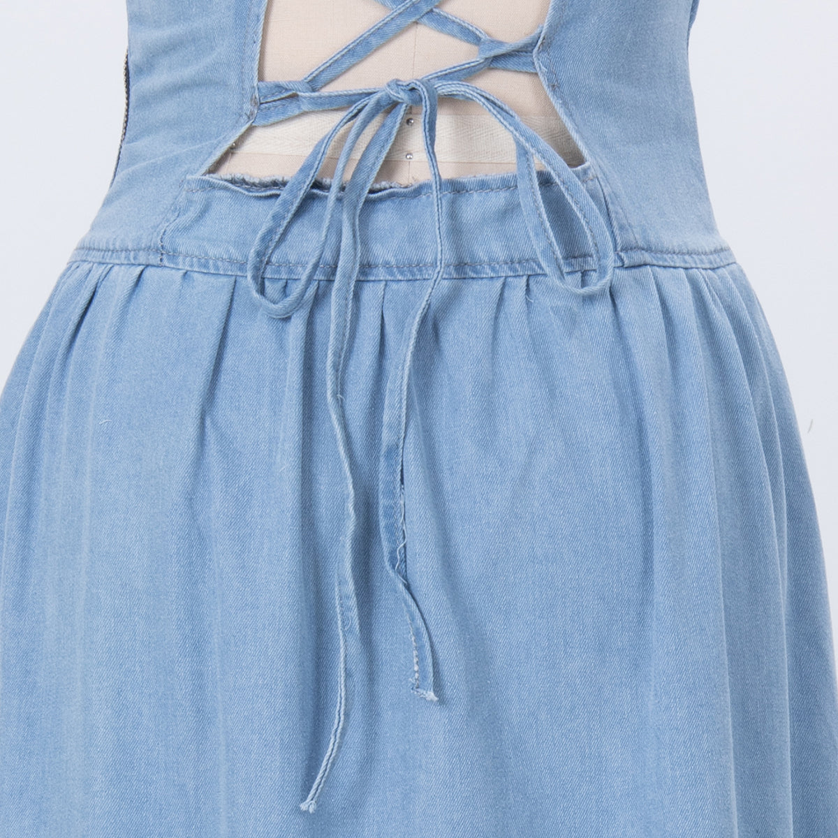 Light blue denim dress bodice with lace-up back ties and gathered skirt ruffle