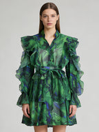 Green ruffle mini dress with V-neck and tie waist, tiered puff sleeves.