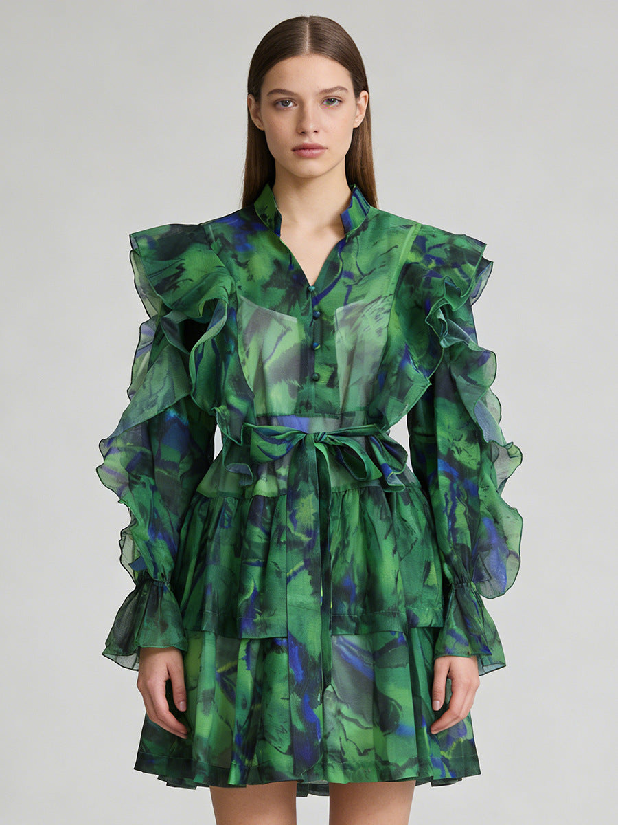 Green ruffle mini dress with V-neck and tie waist, tiered puff sleeves.