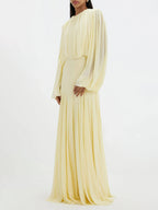 Cream pleated maxi dress with long sleeves and gathered waist, side view