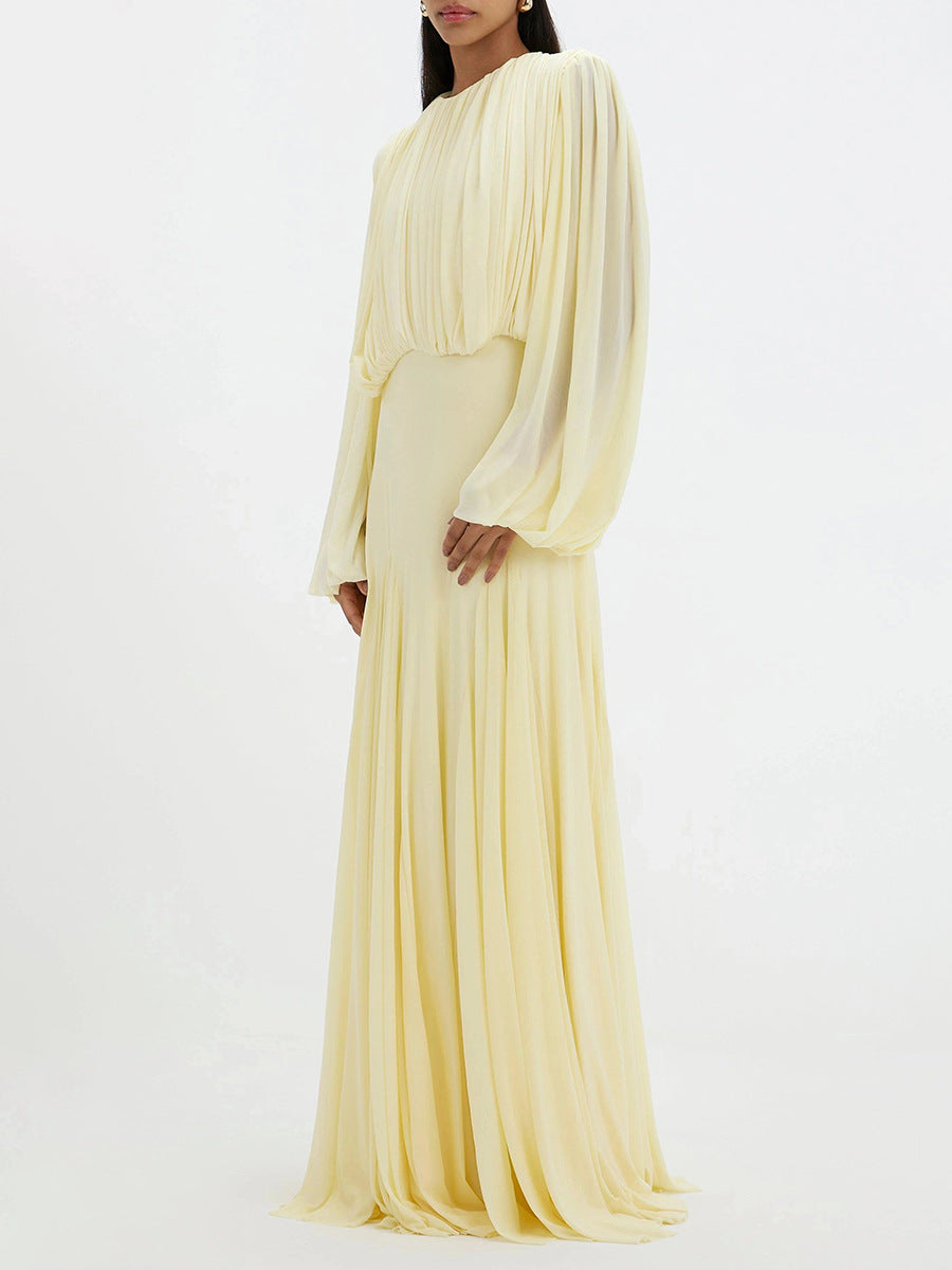 Cream pleated maxi dress with long sleeves and gathered waist, side view