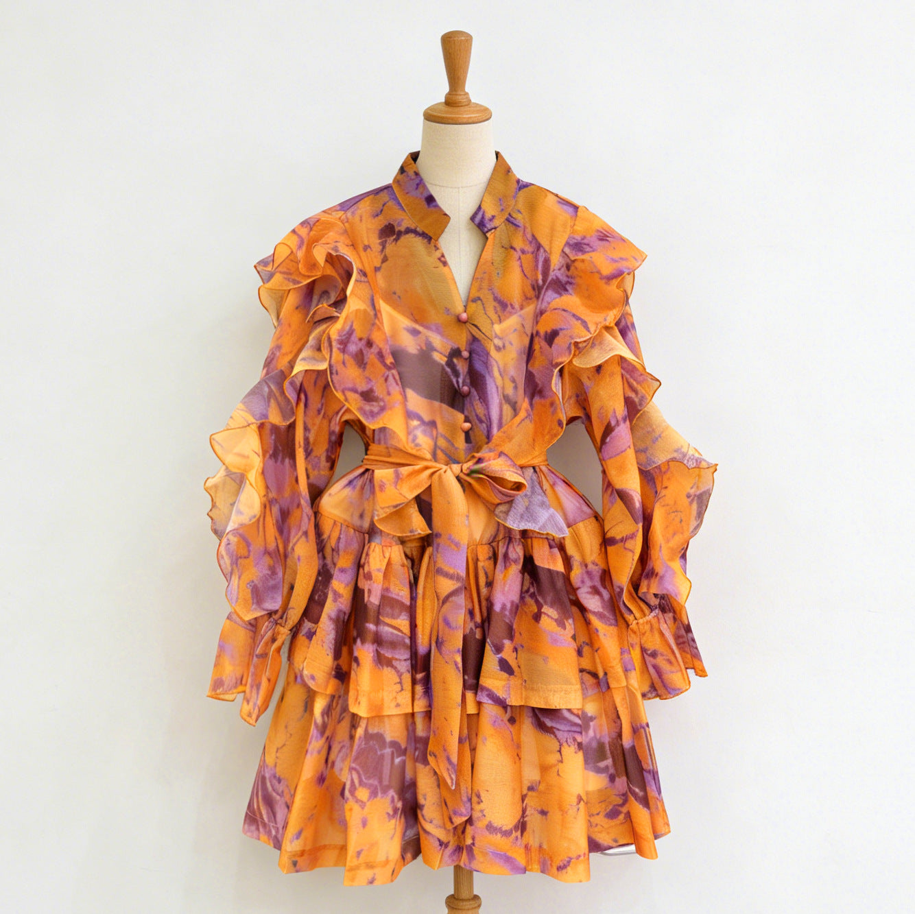 Orange ruffle mini dress with V-neck and tie waist, tiered ruffle sleeves.