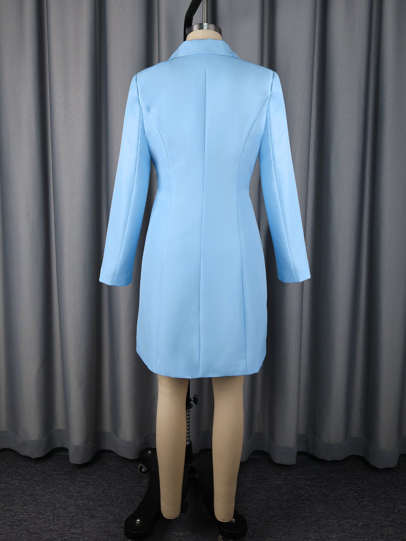 Back view of blue lapel wrap mini blazer dress with long sleeves and waist belt tie