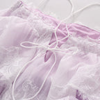 Lavender lace spaghetti straps and tie detail on a tiered slip dress