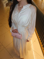 White puff-sleeve button flowy dress with V-neck and cinched waist