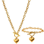 Gold-tone chain necklace set with two heart pendants and toggle bar detail