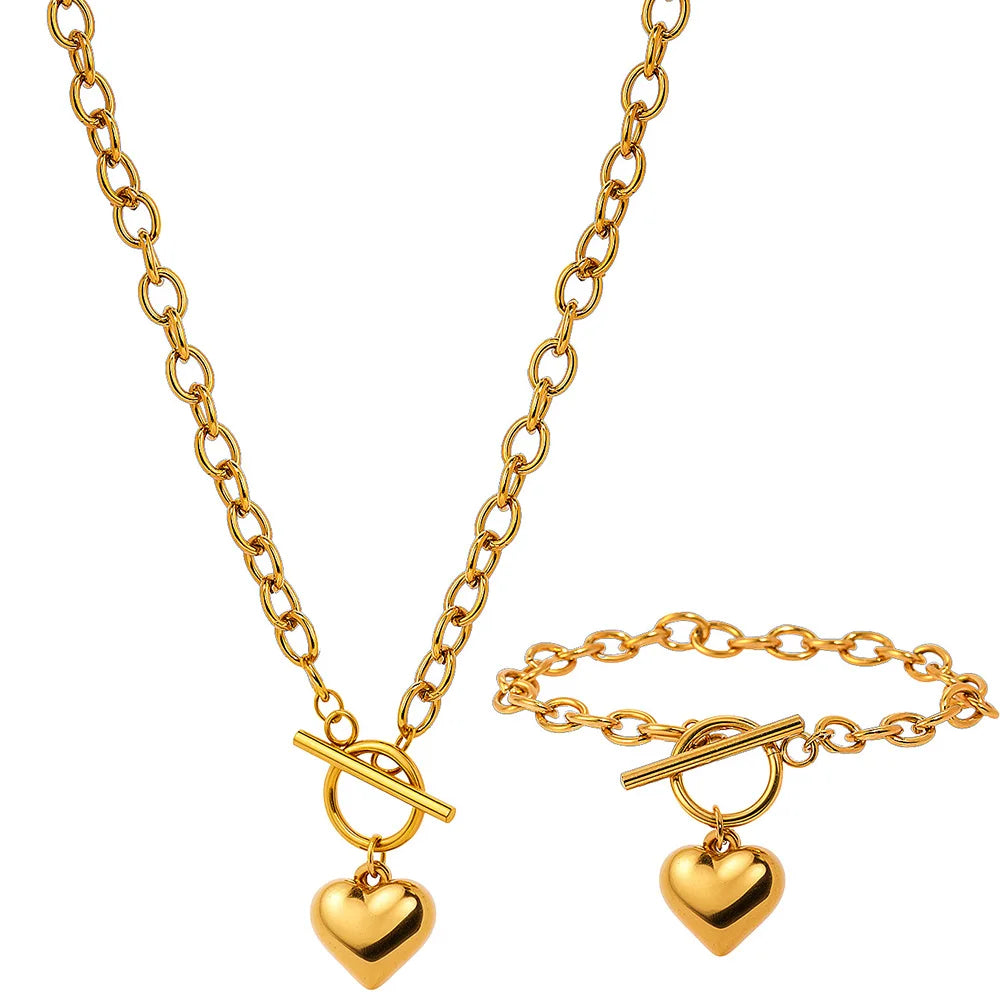 Gold-tone chain necklace set with two heart pendants and toggle bar detail