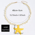 Starfish pendant necklace with white star-link chain, gold clasp, and yellow starfish charm