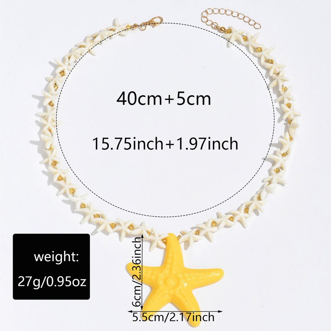 Starfish pendant necklace with white star-link chain, gold clasp, and yellow starfish charm