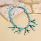 Turquoise bead pendant necklace with coral branch charms and silver spacer beads