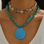 Turquoise conch rope necklace with starfish charms and large blue scallop shell pendant