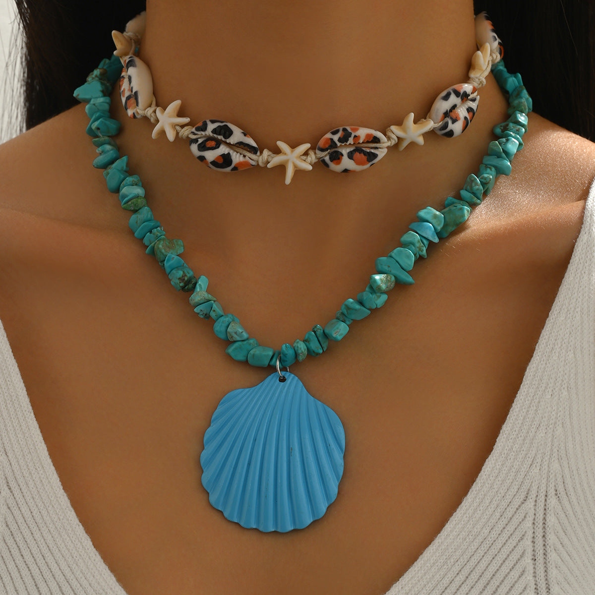 Turquoise conch rope necklace with starfish charms and large blue scallop shell pendant