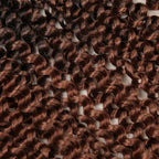 Crochet hair extensions with tight water-wave curls in warm brown ombre.