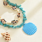 Turquoise rope necklace with conch shells, starfish, and a blue scallop shell charm