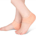 Skin-tone gel heel socks on feet, padded toe-and-heel coverage with dotted nubs