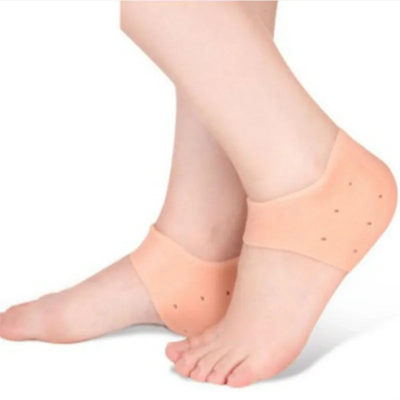Skin-tone gel heel socks on feet, padded toe-and-heel coverage with dotted nubs
