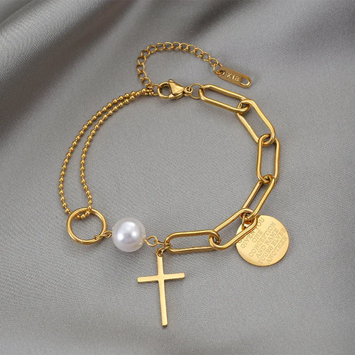 Gold-tone asymmetrical cross pearl chain bracelet with heart disc, pearl, and cross charm