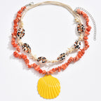 Orange beaded conch rope necklace with starfish charms and yellow scallop shell pendant