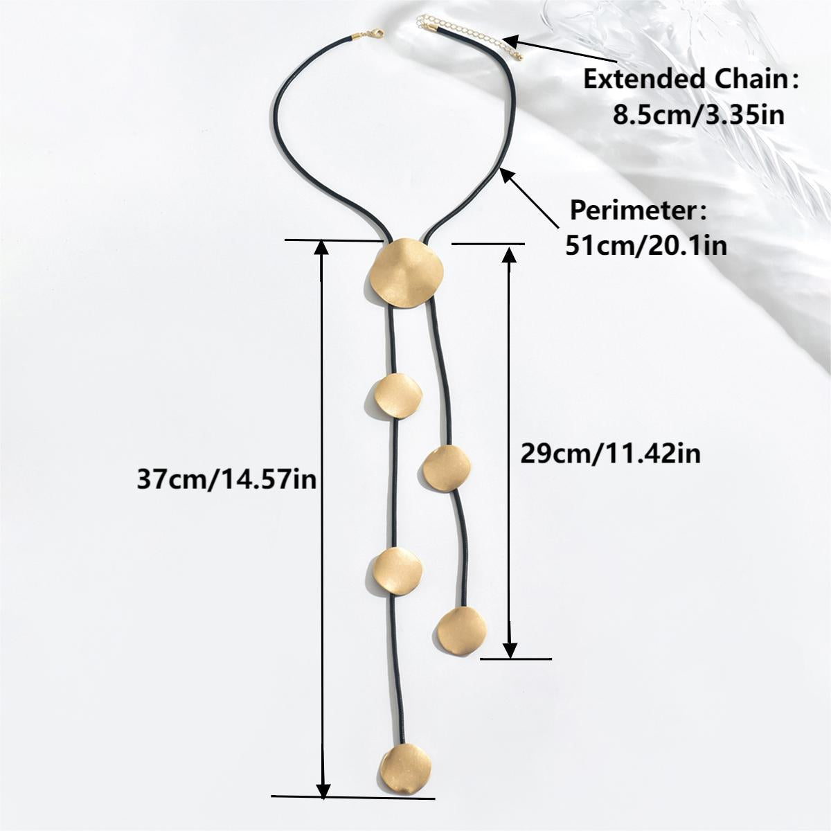 Gold disc tassel necklace on black cord with round metal pendants and extender