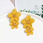 Yellow double-layer flower dangle earrings with gold-tone centers, two stacked petals