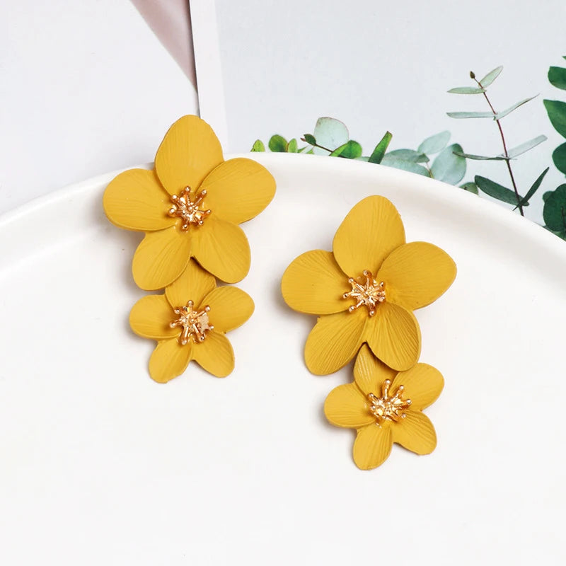 Yellow double-layer flower dangle earrings with gold-tone centers, two stacked petals