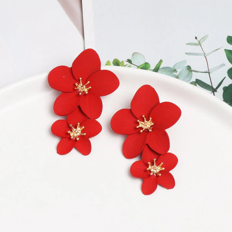 Red double-layer flower dangle earrings with gold-tone centers, two stacked petals