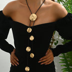 Gold disc tassel necklace with round metal pendants and black cords