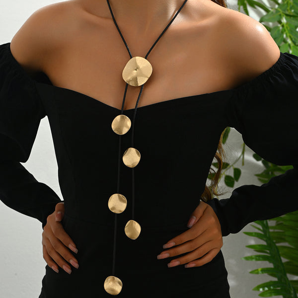 Gold disc tassel necklace with round metal pendants and black cords
