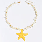 Starfish pendant necklace with white star-link chain and yellow starfish drop