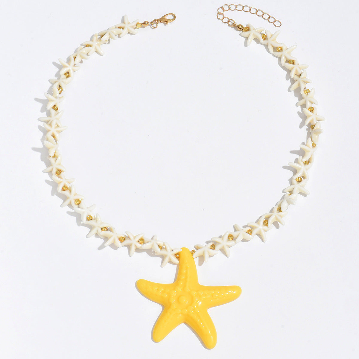 Starfish pendant necklace with white star-link chain and yellow starfish drop