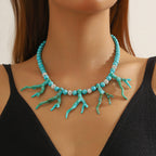 Turquoise bead pendant necklace with coral branch charms and small silver spacers